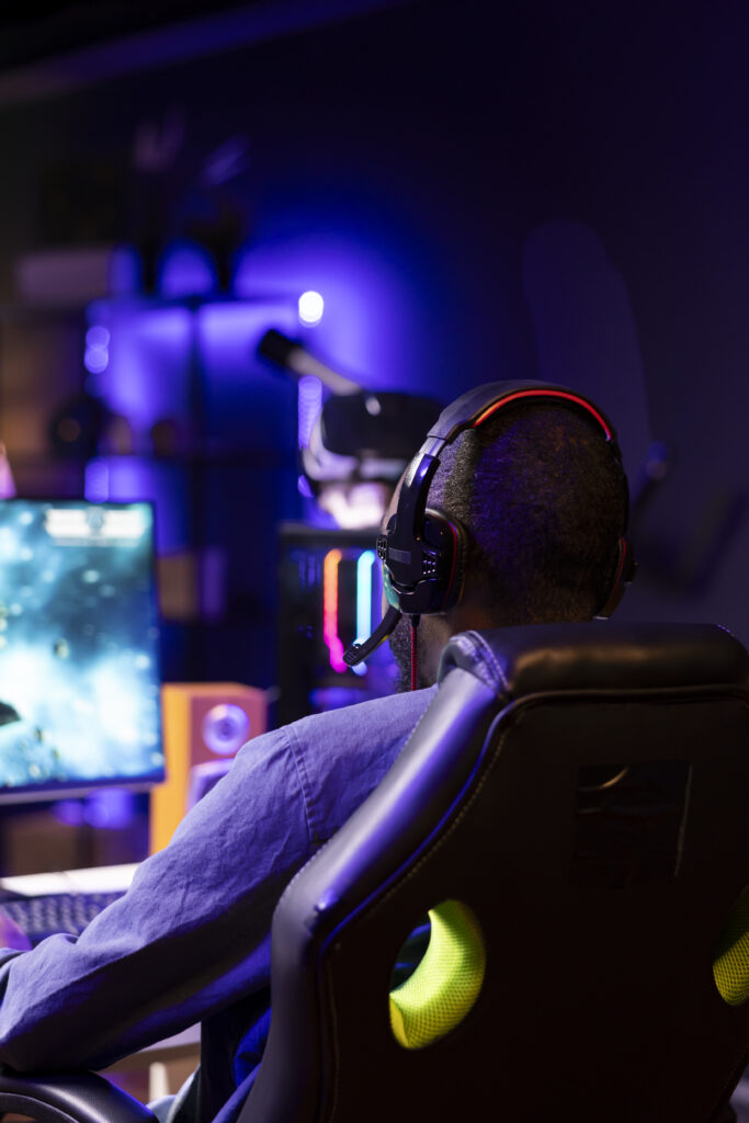 Gamer using headphones to discuss with mates while playing online SF videogame Gamer Using Headphones Discuss With Mates While Playing Online Sf Videogame 683x1024
