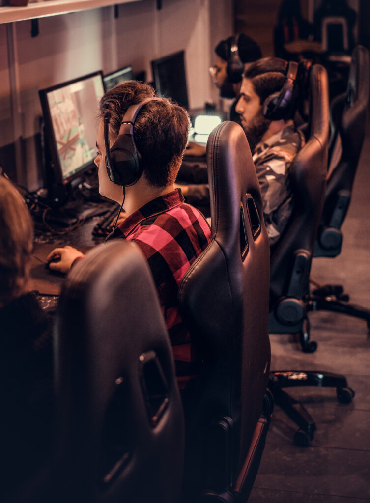team of teenage gamers plays in a multiplayer video game on pc in a gaming club. team of teenage gamers plays in a multiplayer video game on pc in a gaming club.
